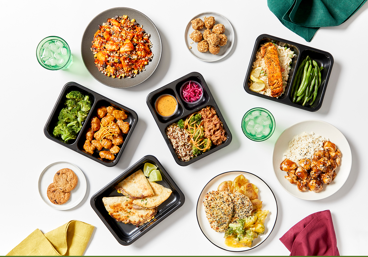 Chef-prepared meals, bowls and containers arranged on a table